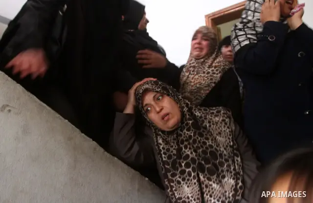 Relative of Palestinians Sobhi al-Batsh, a member of Hamas's armed wing the Ezzedine al-Qassam Brigades, and Issam al-Batsh, a senior member of the Al-Aqsa Martyrs Brigades, mourn at his home during his funeral in Gaza C...