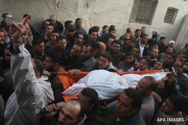 Palestinians carry the bodies of Sobhi al-Batsh, a member of Hamas's armed wing the Ezzedine al-Qassam Brigades, and Issam al-Batsh, a senior member of the Al-Aqsa Martyrs Brigades, outside their home during their funera...