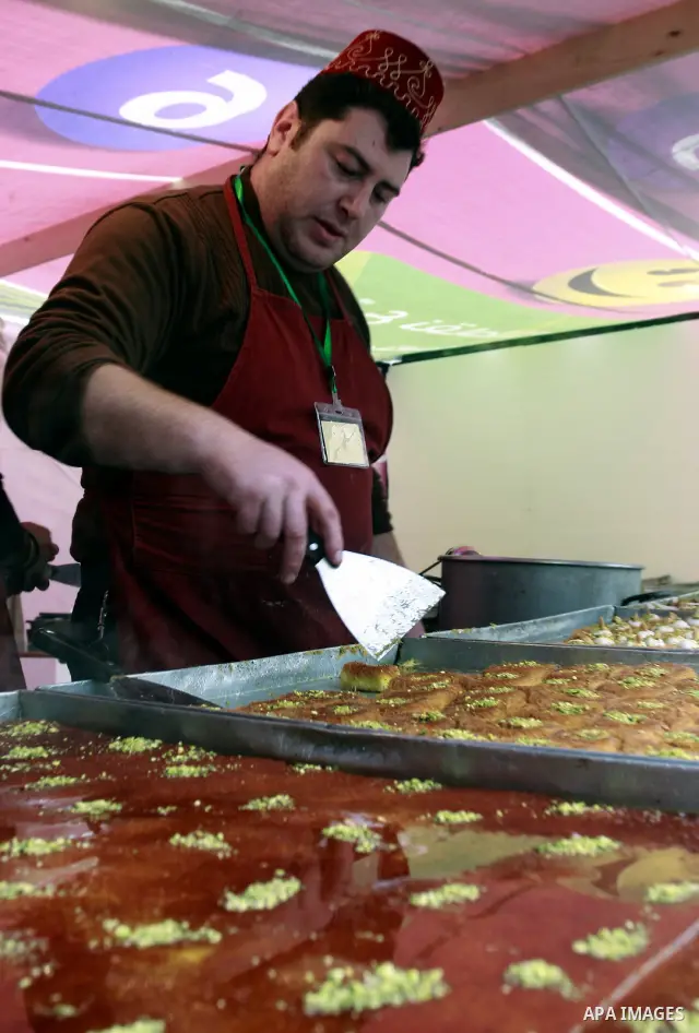 Palestinian bakers prepare a giant Kunafa, a favorite local sweet, during a celebration in the West Bank city of Nablus, Thursday, Dec. 8, 2011. Photo by Wagdi Eshtayah.