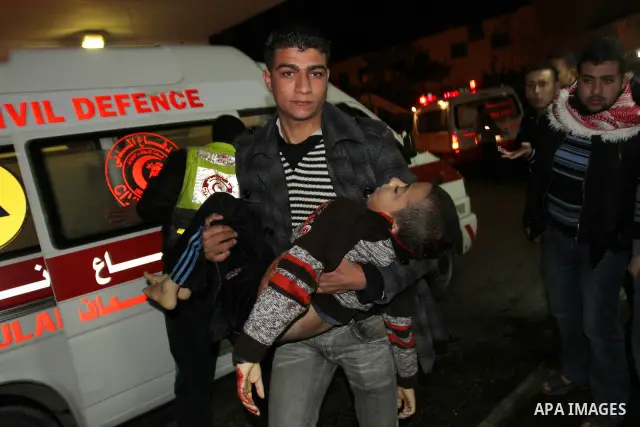 Palestinian men wheel a wounded boy on a stretcher into al-Shifa hospital in Gaza City on 09 December 2011. An Israeli air strike killed at least one Palestinian and wounded others, Palestinian medical and security sourc...