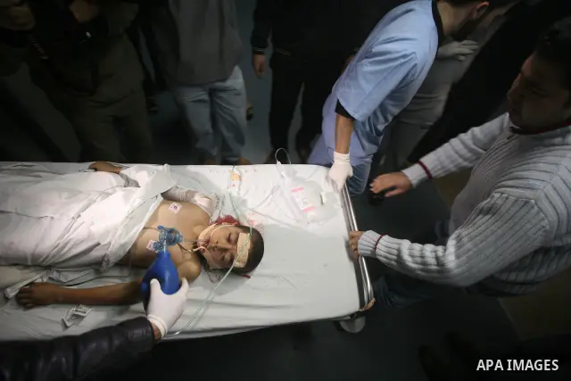 Palestinian doctors care for a wounded boy at al-Shifa hospital in Gaza City on December 9, 2011, after an Israeli air strike killed at least one Palestinians and wounded others, Palestinian medical and security sources...