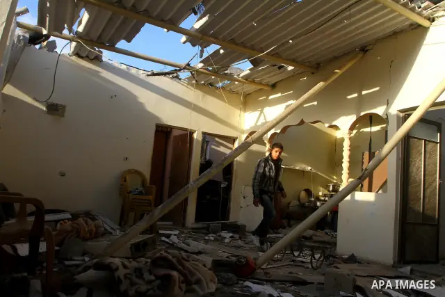 Palestinians inspect a destroyed house in Gaza city on December 9, 2011. Violence across the Israeli-Gaza border escalated on Friday with Israeli air strikes killing at least three people and Palestinian militants firing...
