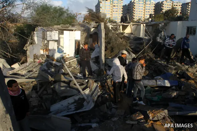 Palestinians inspect a destroyed house in Gaza city on December 9, 2011. Violence across the Israeli-Gaza border escalated on Friday with Israeli air strikes killing at least three people and Palestinian militants firing...