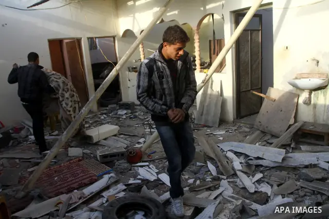 Palestinians inspect a destroyed house in Gaza city on December 9, 2011. Violence across the Israeli-Gaza border escalated on Friday with Israeli air strikes killing at least three people and Palestinian militants firing...