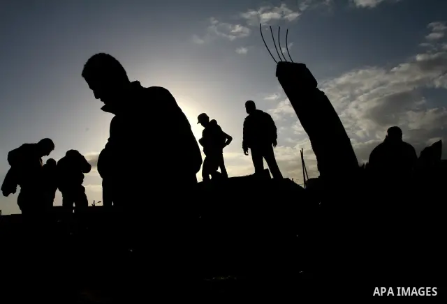 Palestinians survey the site of a Hamas training camp after it was hit in an Israeli air strike in Gaza City on December 9, 2011. Violence across the Israeli-Gaza border escalated on Friday with Israeli air strikes killi...