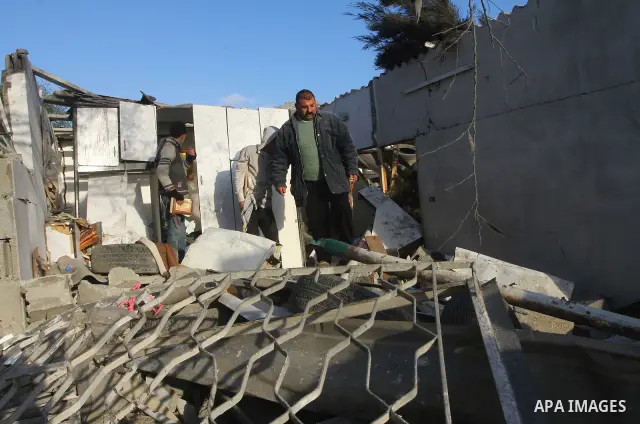 Palestinians inspect a destroyed house in Gaza city on December 9, 2011. Violence across the Israeli-Gaza border escalated on Friday with Israeli air strikes killing at least three people and Palestinian militants firing...