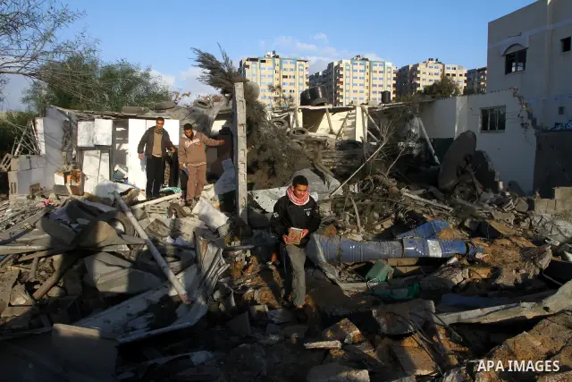 Palestinians inspect a destroyed house in Gaza city on December 9, 2011. Violence across the Israeli-Gaza border escalated on Friday with Israeli air strikes killing at least three people and Palestinian militants firing...