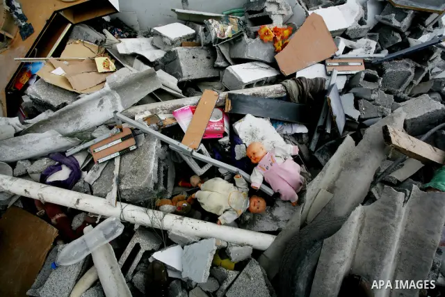Palestinians inspect a destroyed house in Gaza city on December 9, 2011. Violence across the Israeli-Gaza border escalated on Friday with Israeli air strikes killing at least three people and Palestinian militants firing...
