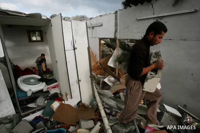 Palestinians inspect a destroyed house in Gaza city on December 9, 2011. Violence across the Israeli-Gaza border escalated on Friday with Israeli air strikes killing at least three people and Palestinian militants firing...