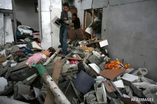 Palestinians inspect a destroyed house in Gaza city on December 9, 2011. Violence across the Israeli-Gaza border escalated on Friday with Israeli air strikes killing at least three people and Palestinian militants firing...