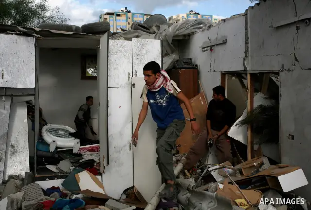 Palestinians inspect a destroyed house in Gaza city on December 9, 2011. Violence across the Israeli-Gaza border escalated on Friday with Israeli air strikes killing at least three people and Palestinian militants firing...