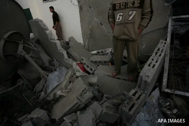 Palestinians inspect a destroyed house in Gaza city on December 9, 2011. Violence across the Israeli-Gaza border escalated on Friday with Israeli air strikes killing at least three people and Palestinian militants firing...