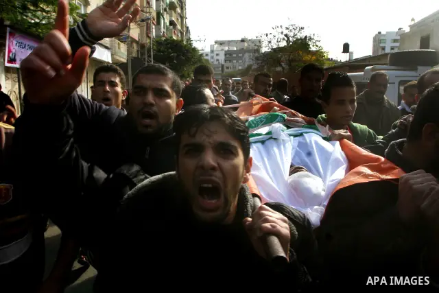 Palestinians carry the body of Bahjat Al-Zalan, who was killed in a blast from an Israeli air strike on a nearby Hamas training camp in Gaza City, during his funeral in Gaza City December 9, 2011. Violence across the Isr...