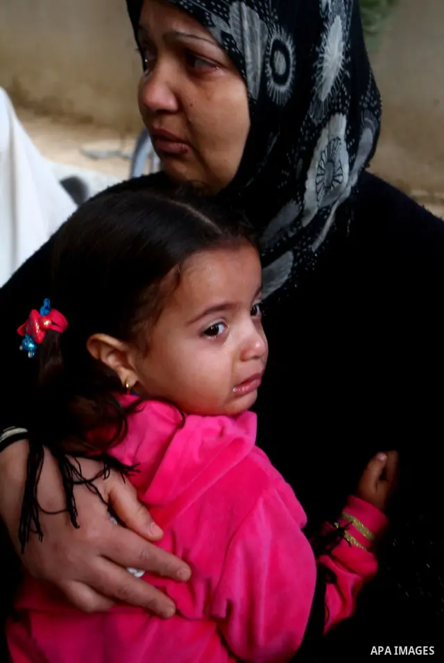 Relatives mourns during the funeral of Palestinian Bahjat Al-Zalan, who was killed in a blast from an Israeli air strike on a nearby Hamas training camp in Gaza City December 9, 2011. Violence across the Israeli-Gaza bor...