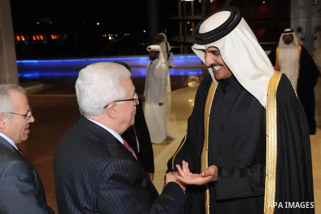 Palestinian President Mahmoud Abbas (Abu Mazen) and Qatari Crown Prince Sheikh Tamim bin Hamad bin Khalifa al-Thani applaud during the opening ceremony of the pan-Arab Games in Doha on December 9, 2011. More than 5,000 A...