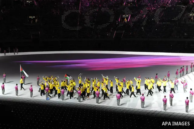 Members of the Palestinian team take part in the opening ceremony of the pan-Arab Games at Sheikh Khalifa stadium in the Qatari capital Doha on December 9, 2011. More than 5,000 Arab athletes are participating in the Ara...