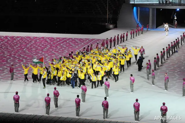 Members of the Palestinian team take part in the opening ceremony of the pan-Arab Games at Sheikh Khalifa stadium in the Qatari capital Doha on December 9, 2011. More than 5,000 Arab athletes are participating in the Ara...
