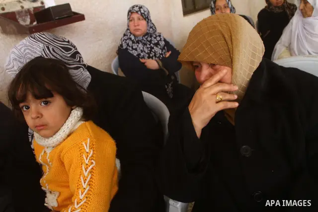 Relatives mourn during the funeral of Palestinian boy Ramadan Al-Zalan, who was killed in a blast from an Israeli air strike on a nearby Hamas training camp, in Gaza City December 10, 2011. Violence has flared up between...