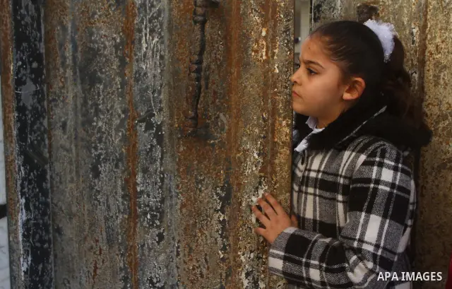 A Palestinian girl looks the funeral of Ramadan Bahajat Zaalan, 12, during his funeral in Gaza City, Saturday, Dec. 10, 2011. Ramadan died of his injuries later Friday after an Israeli strike. Israeli forces had carried...