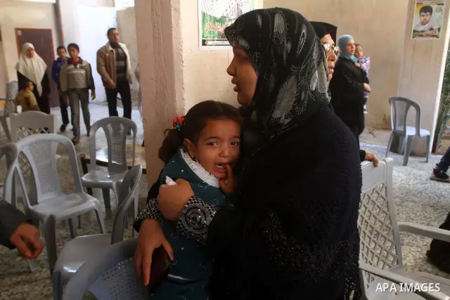 Relatives mourn during the funeral of Palestinian boy Ramadan Al-Zalan, who was killed in a blast from an Israeli air strike on a nearby Hamas training camp, in Gaza City December 10, 2011. Violence has flared up between...