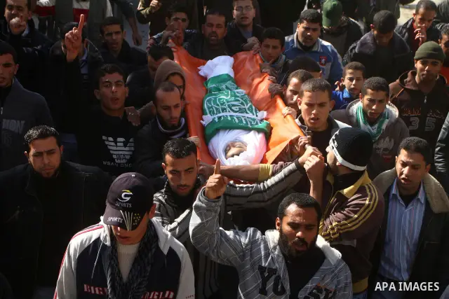 Palestinians carry the body of Ramadan Al Zalan, 12, at his family house during his funeral in Al Shatea refugee camp in the west of Gaza City on, 10 December 2011. Ramadan was injured yesterday and his father Bahjat Al...