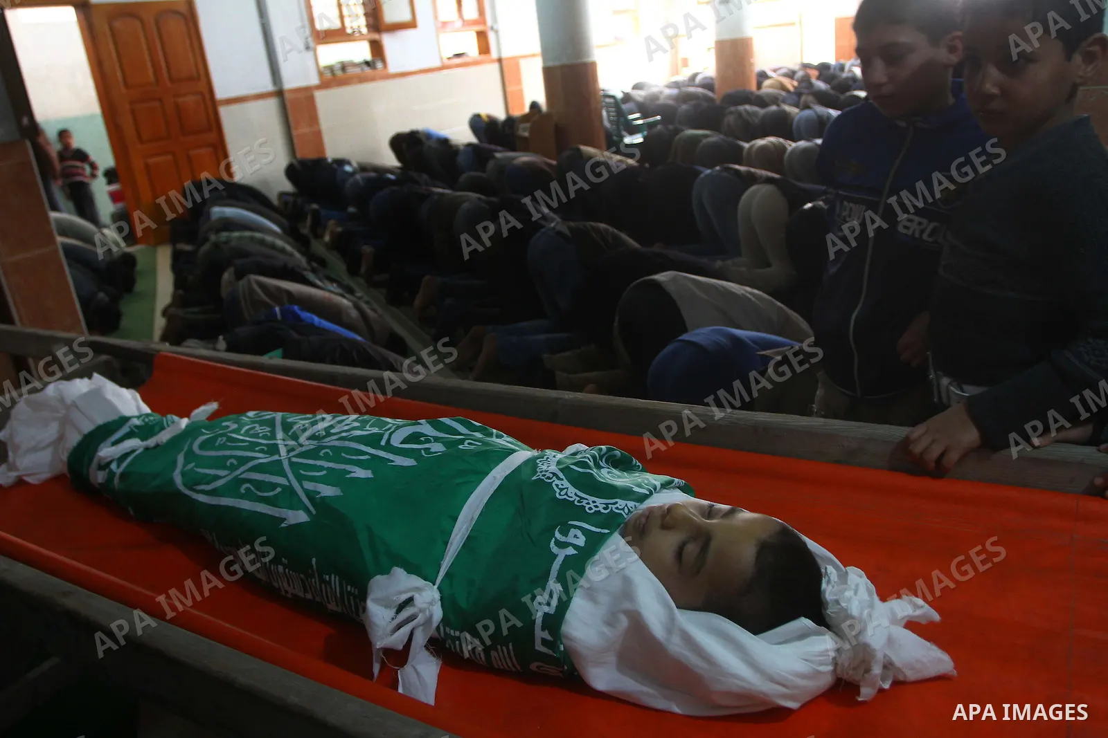 Palestinian mourners perform the prayers on the body of Ramadan al-Zaalan,12, during his funeral in Al Shatea refugee camp in the west of Gaza City on, 10 December 2011. Ramadan was injured yesterday and his father Bahja...