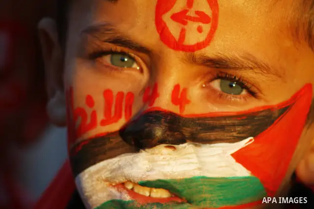 Palestinian supporters of the Popular Front for the Liberation of Palestine (PLFP) wave the group's red flags during a rally held in the northern Gaza Strip town of Beit Lahia on December 10, 2011 to its 44th anniversary...