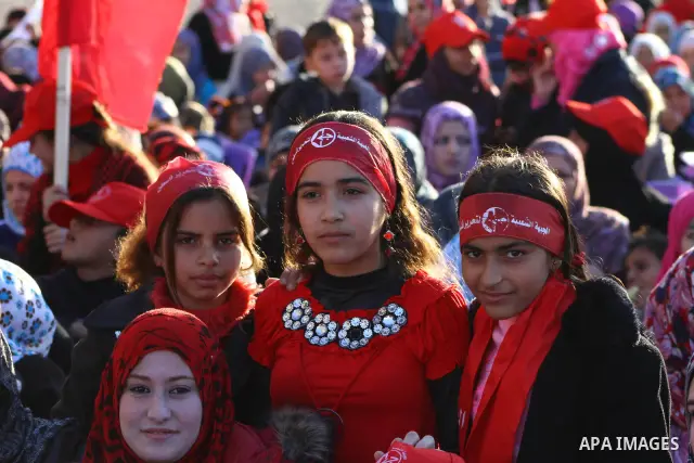 Palestinian supporters of the Popular Front for the Liberation of Palestine (PLFP) wave the group's red flags during a rally held in the northern Gaza Strip town of Beit Lahia on December 10, 2011 to its 44th anniversary...