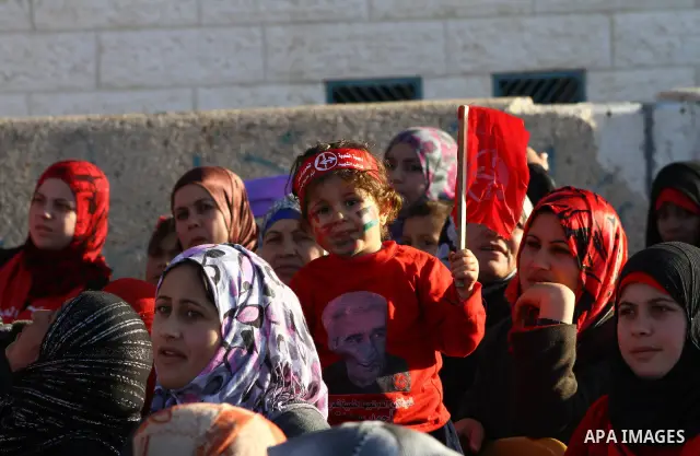 Palestinian supporters of the Popular Front for the Liberation of Palestine (PLFP) wave the group's red flags during a rally held in the northern Gaza Strip town of Beit Lahia on December 10, 2011 to its 44th anniversary...