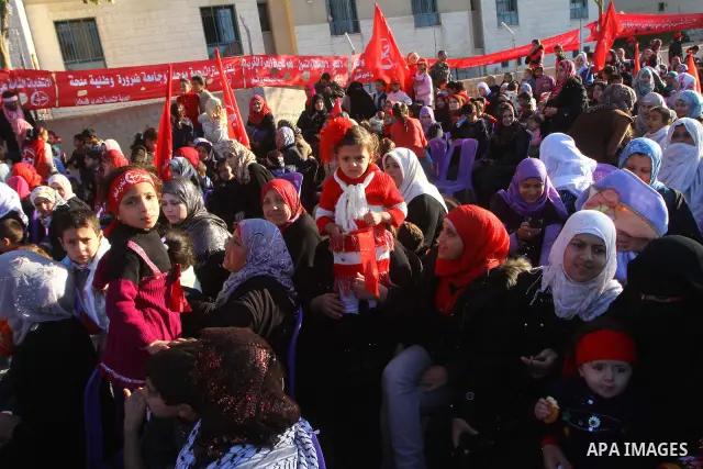Palestinian supporters of the Popular Front for the Liberation of Palestine (PLFP) wave the group's red flags during a rally held in the northern Gaza Strip town of Beit Lahia on December 10, 2011 to its 44th anniversary...
