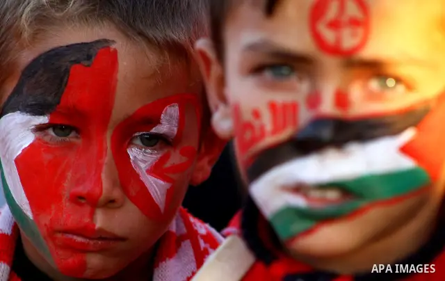 Palestinian supporters of the Popular Front for the Liberation of Palestine (PLFP) wave the group's red flags during a rally held in the northern Gaza Strip town of Beit Lahia on December 10, 2011 to its 44th anniversary...