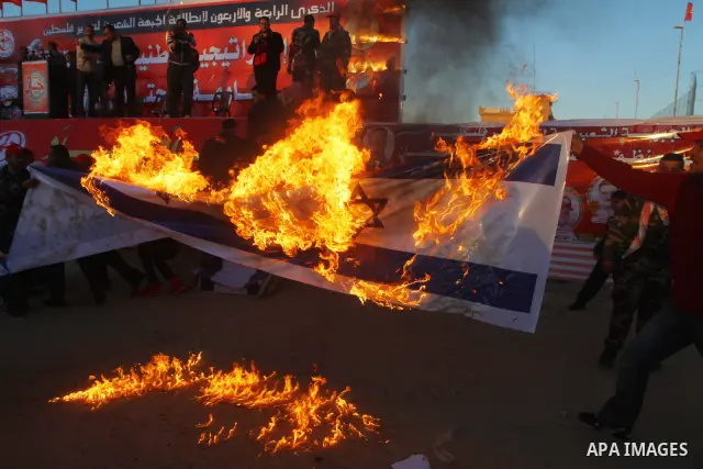 Palestinian supporters of the Popular Front for the Liberation of Palestine (PLFP) wave the group's red flags during a rally held in the northern Gaza Strip town of Beit Lahia on December 10, 2011 to its 44th anniversary...
