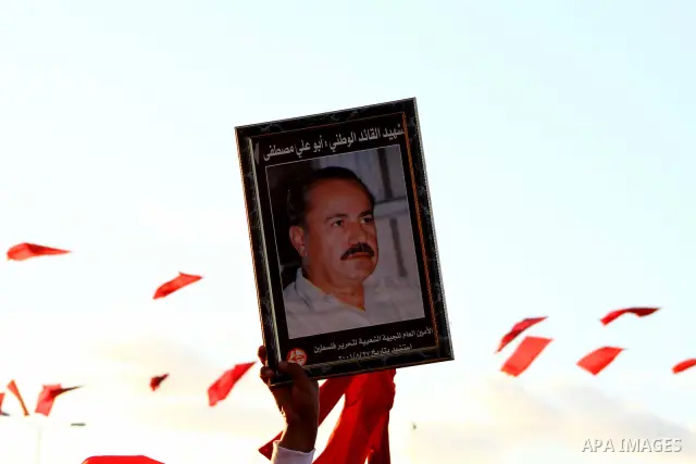 Palestinian supporters of the Popular Front for the Liberation of Palestine (PLFP) wave the group's red flags during a rally held in the northern Gaza Strip town of Beit Lahia on December 10, 2011 to its 44th anniversary...