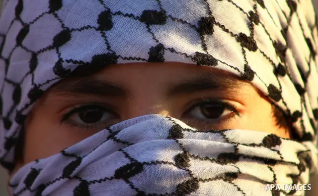 Masked Palestinian boys take part in a rally organized by the Popular Front for the Liberation of Palestine (PFLP) to celebrate the 44th anniversary of its foundation, in northern Gaza Strip December 10, 2011. Photo by A...