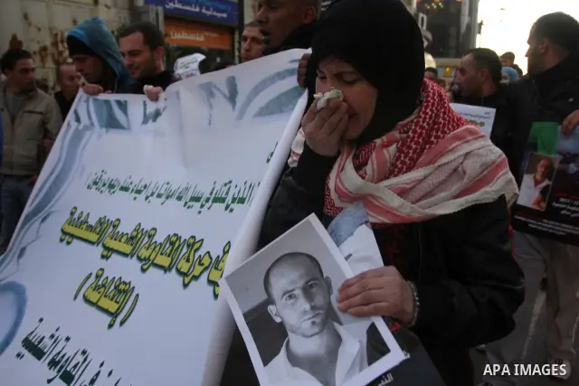 Relatives of Palestinian activist Mustafa Abdelrazek al-Tamimi who died on December 10, 2011 after he was fatally wounded by tear gas the previous day, comfort each other during condolences in the village of Nabi Saleh,...
