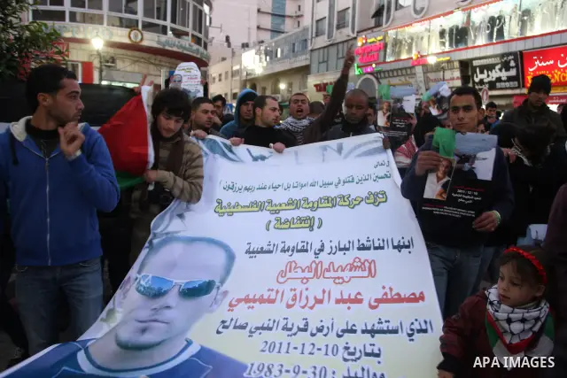 Relatives of Palestinian activist Mustafa Abdelrazek al-Tamimi who died on December 10, 2011 after he was fatally wounded by tear gas the previous day, comfort each other during condolences in the village of Nabi Saleh,...
