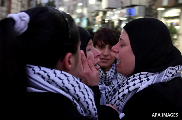 Relatives of Palestinian activist Mustafa Abdelrazek al-Tamimi who died on December 10, 2011 after he was fatally wounded by tear gas the previous day, comfort each other during condolences in the village of Nabi Saleh,...
