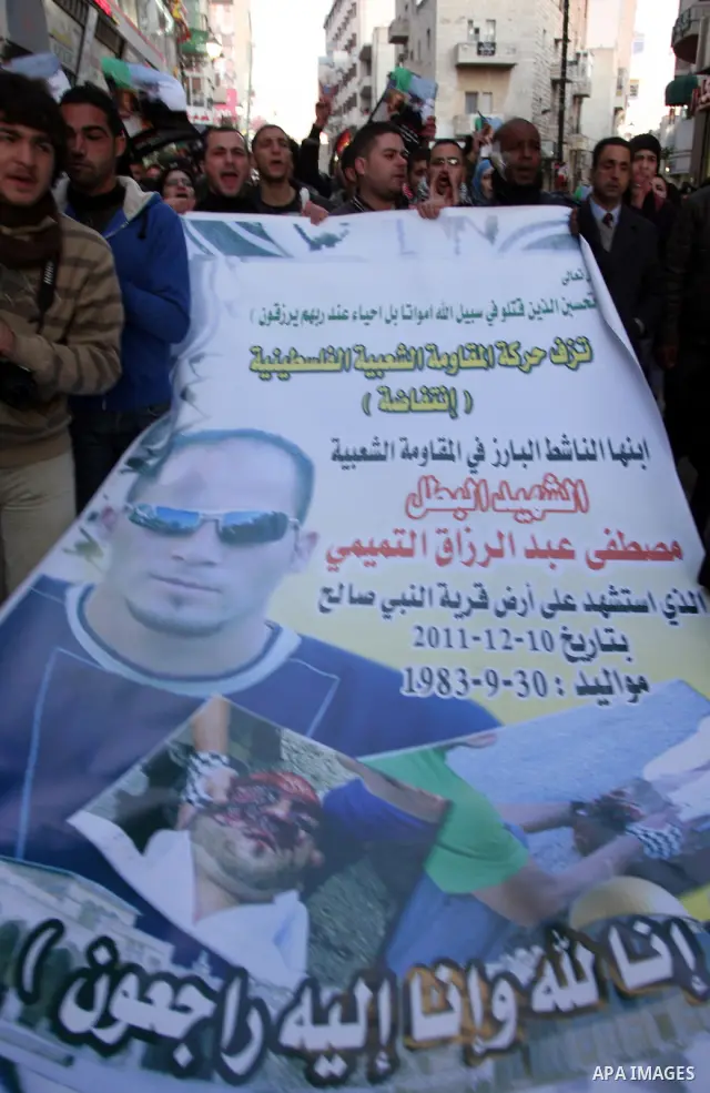 Relatives of Palestinian activist Mustafa Abdelrazek al-Tamimi who died on December 10, 2011 after he was fatally wounded by tear gas the previous day, comfort each other during condolences in the village of Nabi Saleh,...