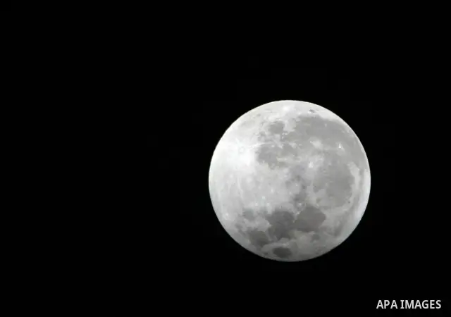 The Earth casts its shadow across the moon's surface during a lunar eclipse in Rafah, in the southern of Gaza Strip on Dec. 10, 2011. This is the second total lunar eclipse of the year and the last until 2014. Photo by A...