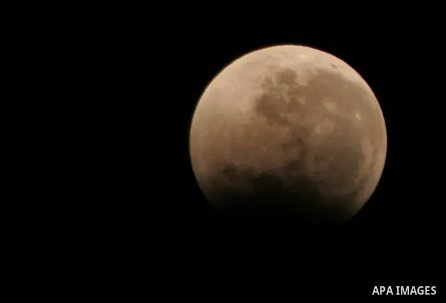 The Earth casts its shadow across the moon's surface during a lunar eclipse in Rafah, in the southern of Gaza Strip on Dec. 10, 2011. This is the second total lunar eclipse of the year and the last until 2014. Photo by A...