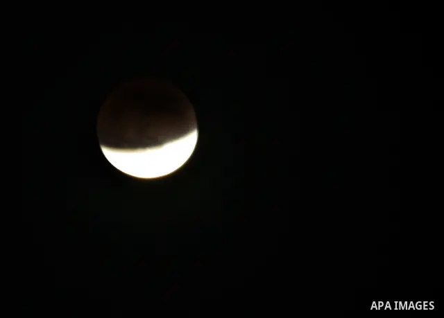 The Earth casts its shadow across the moon's surface during a lunar eclipse in Rafah, in the southern of Gaza Strip on Dec. 10, 2011. This is the second total lunar eclipse of the year and the last until 2014. Photo by A...
