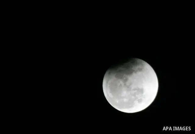 The Earth casts its shadow across the moon's surface during a lunar eclipse in Rafah, in the southern of Gaza Strip on Dec. 10, 2011. This is the second total lunar eclipse of the year and the last until 2014. Photo by A...
