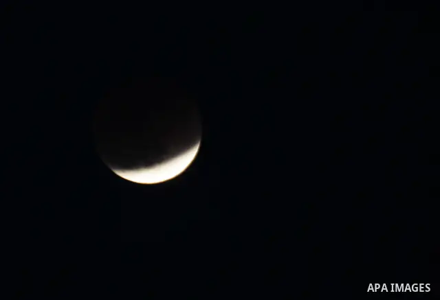 The Earth casts its shadow across the moon's surface during a lunar eclipse in Rafah, in the southern of Gaza Strip on Dec. 10, 2011. This is the second total lunar eclipse of the year and the last until 2014. Photo by A...
