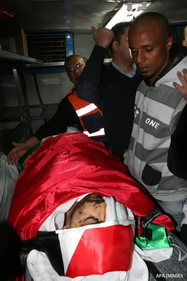 The body of Mustafa Tamimi is seen at the morgue of Ramallah Hospital in the West Bank city of Ramallah, Saturday, Dec. 10, 2011. Tamini, 28, was hurling rocks at an Israeli military vehicle on Friday in the West Bank vi...
