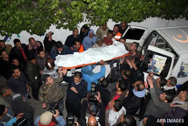 The body of Mustafa Tamimi is seen at the morgue of Ramallah Hospital in the West Bank city of Ramallah, Saturday, Dec. 10, 2011. Tamini, 28, was hurling rocks at an Israeli military vehicle on Friday in the West Bank vi...