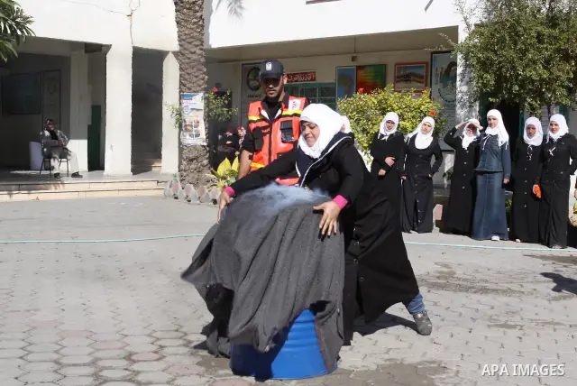 Members of the Palestinian civil defence demonstrate thier skills during a training session following the campaign "your Safety", in school of the girls in Gaza city on Dec. 11, 2011. Photo by Mohammed Asad