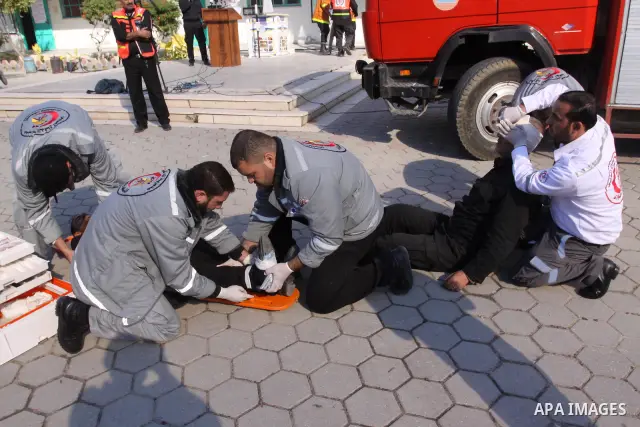 Members of the Palestinian civil defence demonstrate thier skills during a training session following the campaign "your Safety", in school of the girls in Gaza city on Dec. 11, 2011. Photo by Mohammed Asad
