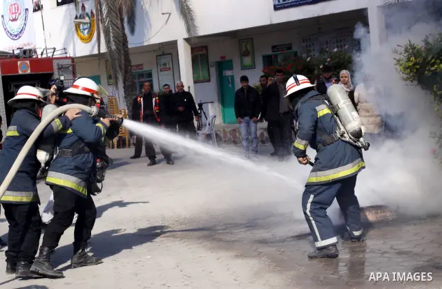Members of the Palestinian civil defence demonstrate thier skills during a training session following the campaign "your Safety", in school of the girls in Gaza city on Dec. 11, 2011. Photo by Mohammed Asad