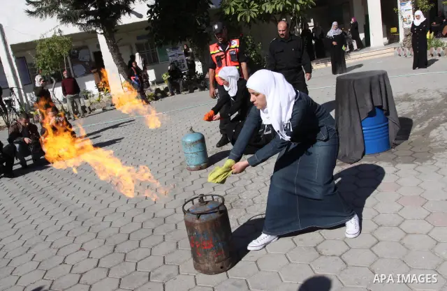 Members of the Palestinian civil defence demonstrate thier skills during a training session following the campaign "your Safety", in school of the girls in Gaza city on Dec. 11, 2011. Photo by Mohammed Asad