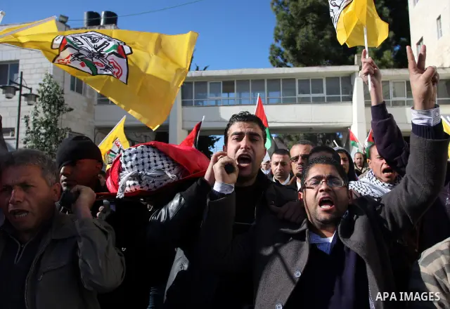 Palestinians carry the body of Mustafa Tamimi during his funeral in the West Bank city of Ramallah, Sunday, Dec. 11, 2011. Tamini, 28, was hurling rocks at an Israeli military vehicle on Friday in the West Bank village o...